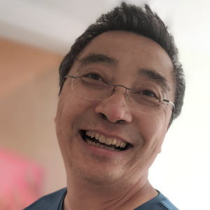 Laughing person with glasses and dark hair